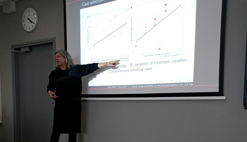 presenter in front of the slides