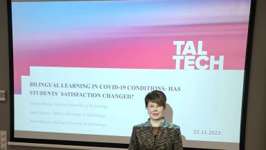 presenter in front of the slides