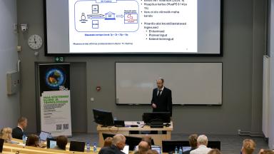 man in suit speaking to an audience
