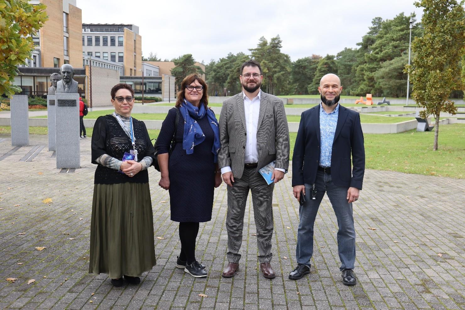 four people standing