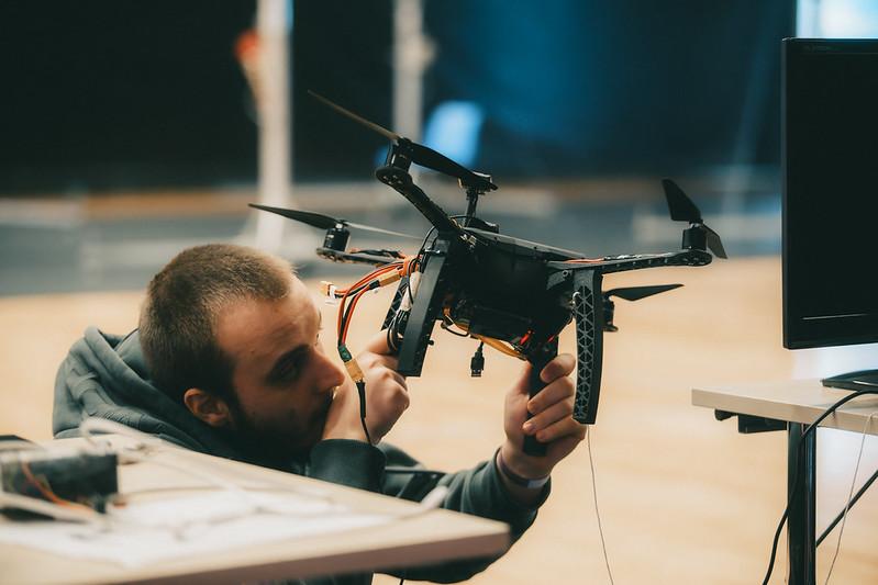 TalTech drone engineer setting up a drone during a workshop.